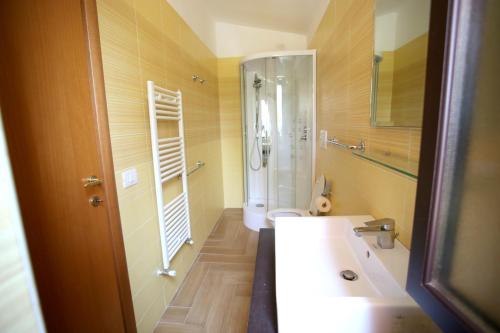 a bathroom with a shower and a white sink at Charming House in Vieste with Shared Pool and Terrace in Vieste