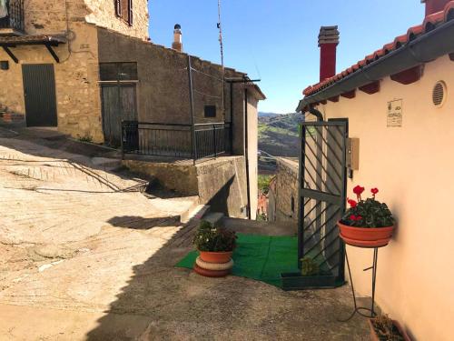 a house with two flower pots on the side of it at One bedroom apartement with furnished balcony at Montenero di Bisaccia in Montenero di Bisaccia