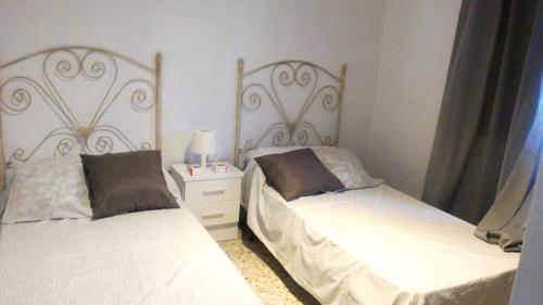 two beds sitting next to each other in a bedroom at 2 bedrooms villa with sea view private pool and enclosed garden at Frigiliana 4 km away from the beach in Frigiliana