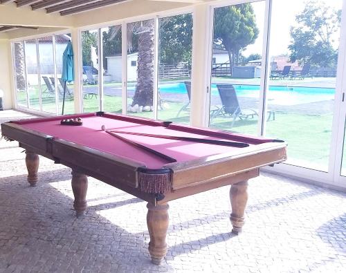 a pool table sitting inside of a house at Spacious Villa in Palmela with Private Pool and Garden in Palmela