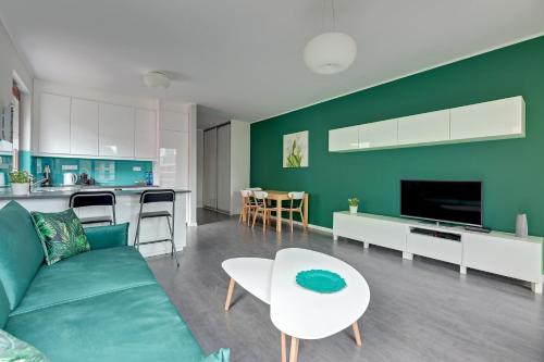 a living room with a couch and a table at Garnizon Apartments & Free Parking by Downtown Apartments in Gdańsk