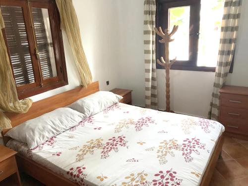 a bedroom with a bed and a window at Spacious apartment with terrace in Cabo Negro, 70 m² + Pool in Cabo Negro