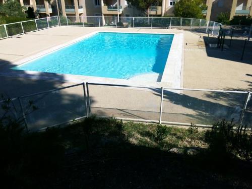 une piscine entourée d'une clôture dans l'établissement Appartement charmant Villeneuve-lès-Avignon, 55 m² + Terrasse, à Villeneuve-lès-Avignon