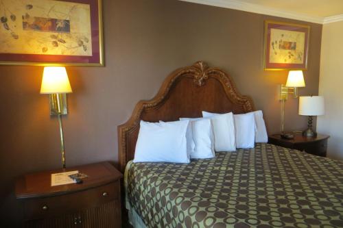 A bed or beds in a room at American Inn Stockton