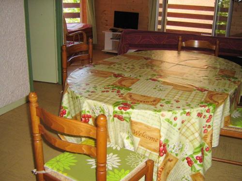 a table with a quilt on it in a room at Studio avec balcon amenage a Cauterets in Cauterets