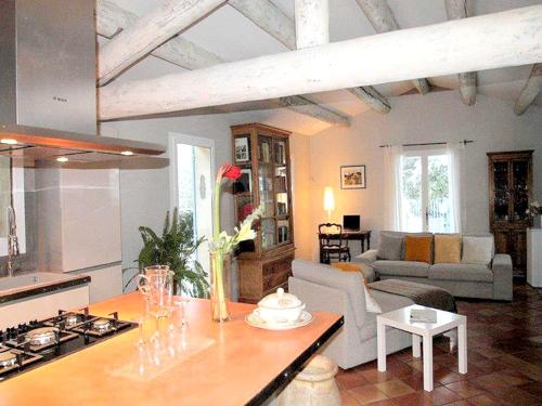 une cuisine et un salon avec un canapé et une table dans l'établissement Maison de charme en campagne à Cucuron avec piscine privée, à Cucuron