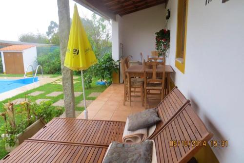 a patio with a table and a yellow umbrella at Charming Villa near Anta with Private Pool in Anta