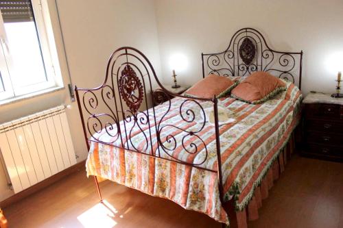 a bedroom with a bed with a wrought iron headboard at Peaceful villa in São Martinho de Mouros with private pool in Frende