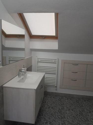 a bathroom with a sink and a mirror at MIG HOME in Horezu