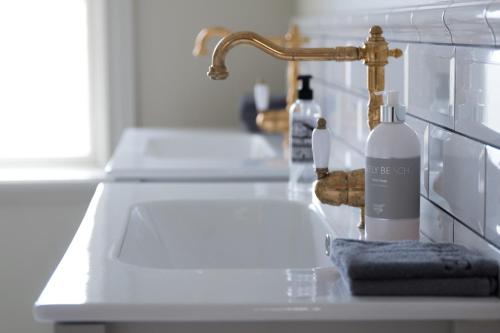 a kitchen counter with a sink and a faucet at Hotell Conrad in Karlskrona