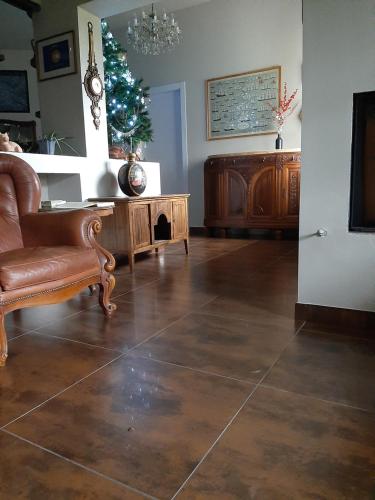 a living room with a leather chair and a table at B&B La Fenice sul Lago in Villongo SantʼAlessandro