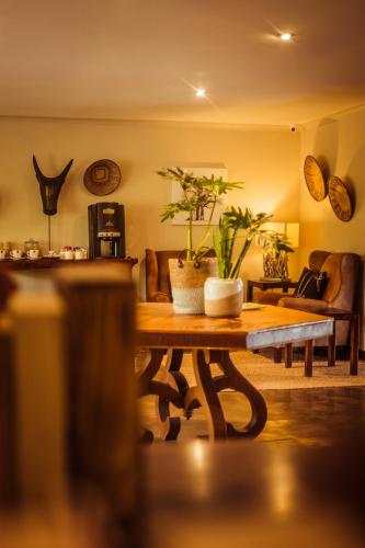 a living room with a table with plants on it at Bushveld Terrace Safari Hotel, Lodge & Spa in Phalaborwa