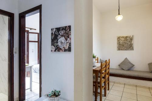 a living room with a table and a dining room at Kasteli Studios & Apartments in Panormos Rethymno