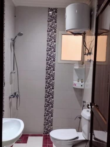 a bathroom with a toilet and a sink at ديالا للشقق المخدومة1 in Riyadh