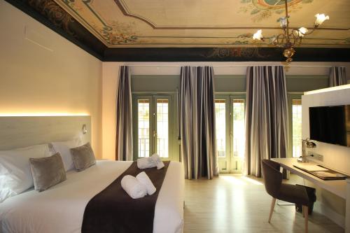 Palacio La Floresta tesisinde bir odada yatak veya yataklar