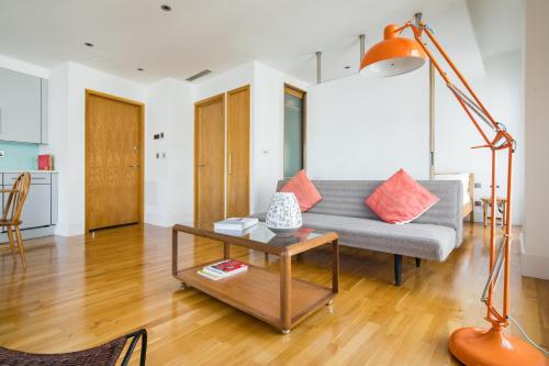 a living room with a couch and a table at Soulful Central London Apartment in London