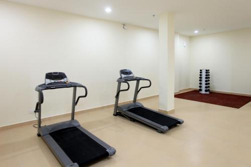 two exercise bikes in a room with a wall at Merdeka Suites Hotel in Miri