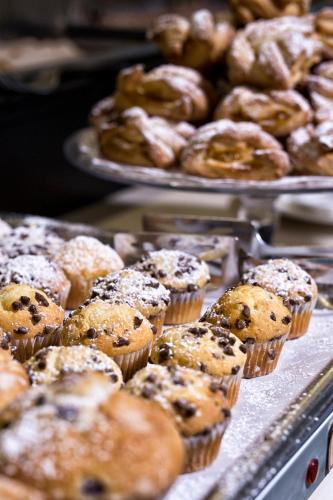 a bunch of muffins and other pastries on a table at Hotel Desenzano in Desenzano del Garda