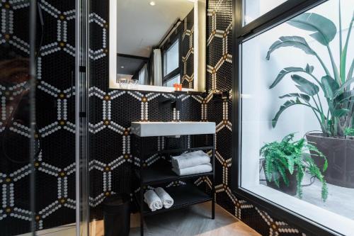 a bathroom with a sink and a mirror at Reina 107 Beach Boutique in Valencia