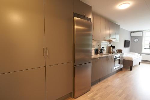 a kitchen with a stainless steel refrigerator at Ekebyhov Hotell in Ekerö