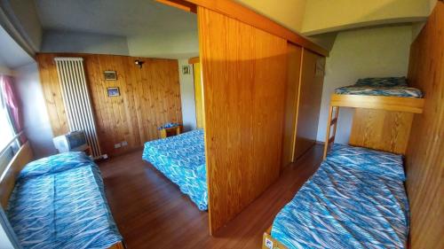 a small room with two beds in a room at Res. Sole Alto appartamenti Solandra in Mezzana