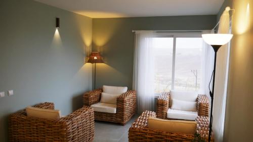 a living room with chairs and a window at Olives in Arad