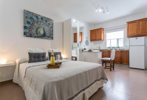 a bedroom with a bed and a kitchen at Studio near the Sea and City in Las Palmas de Gran Canaria