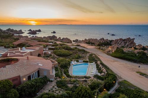 an aerial view of a house and the ocean at Le Sfumature di Melograno in Costa Paradiso