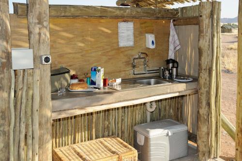 a kitchen with a sink and a counter top at Sossus Oasis Campsite in Sesriem