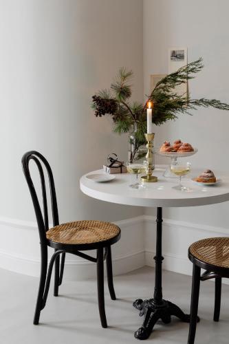 a table with two chairs and a candle on it at Lwowska Studios - STAYINWARSAW in Warsaw
