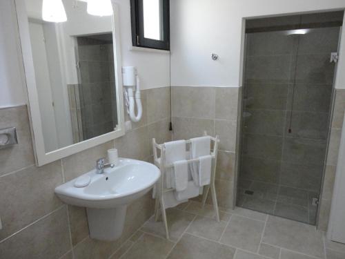a bathroom with a sink and a shower at Masseria Santa Teresa in Monopoli