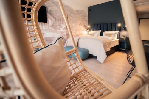 a hotel room with a bed and a swing at Romantik Hotel FreiWerk in Stolberg