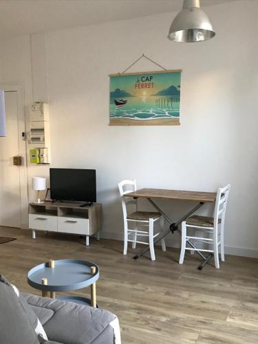 a living room with a desk and a table and chairs at Le Clos Beaufleury in Bordeaux