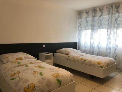 une chambre avec deux lits et une fenêtre dans l'établissement Studio Lora 51B, à Saint-Louis