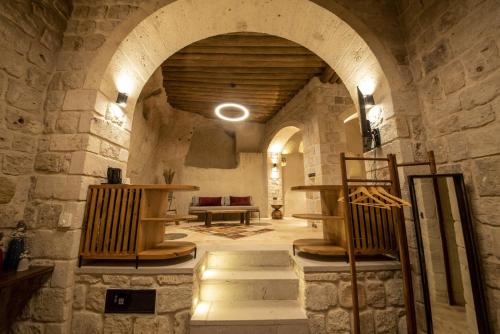 a room with an archway in a stone building at Luvi Cave Hotel in Goreme