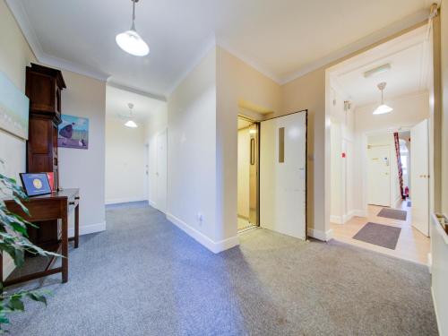 a hallway with white walls and a hallway with a door at The Regent Guest House in Southampton