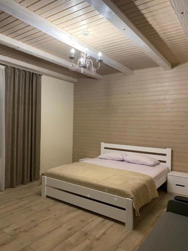 a bedroom with a large bed in a room at Солодкий Гранат in Slavske