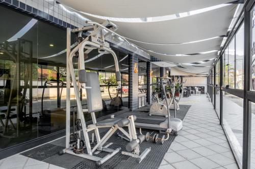 a gym with cardio equipment in a building at OYO Residencial Itacuruçá Apart Hotel in Itacuruçá