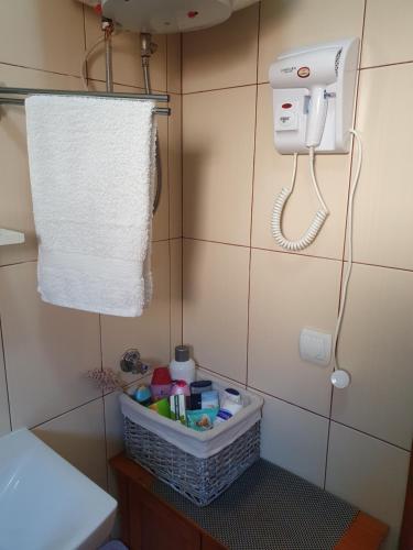 a bathroom with a toilet with a towel and a phone at Apartman "MILLAN" in Prijedor