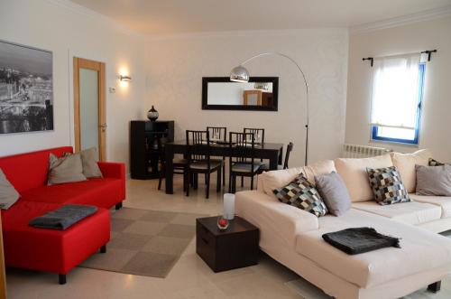 a living room with two couches and a dining room at The Sea at Your Fingertips in Cascais