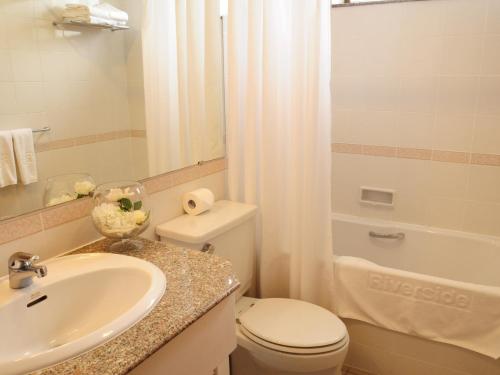 y baño con lavabo, aseo y ducha. en Riverside Serviced Apartments, en Ho Chi Minh