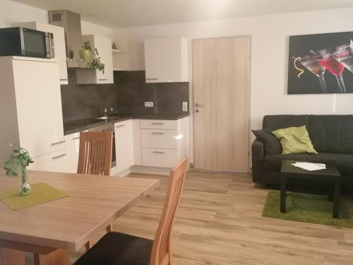 a kitchen and living room with a table and a couch at Ferienhaus Sporer in Iselsberg