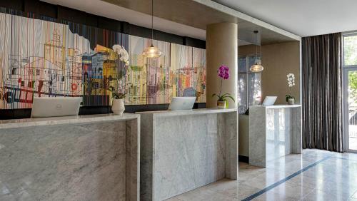 a lobby with two laptops on a wall at Hyatt Regency Cape Town in Cape Town