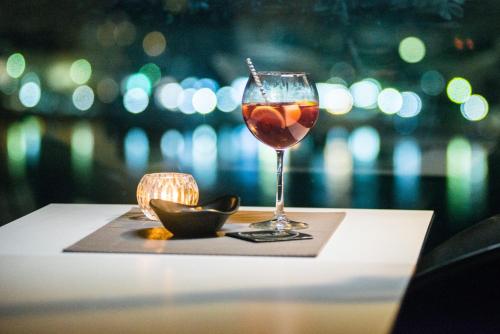 a glass of wine sitting on top of a table at Hara Hotel in Chalkida