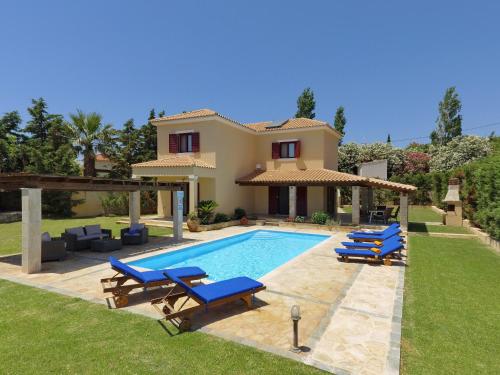 a villa with a swimming pool and a house at Villa Estia Spartia Kefalonia in Kefallonia
