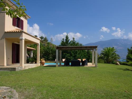 a yard with a gazebo next to a house at Villa Estia Spartia Kefalonia in Kefallonia