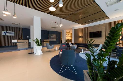 an office lobby with chairs and a living room at Holiday Inn Express Warsaw - Mokotow by IHG in Warsaw