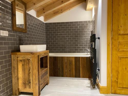 a bathroom with a sink and a mirror at Chalet Beaufort in Saint-Martin-de-Belleville