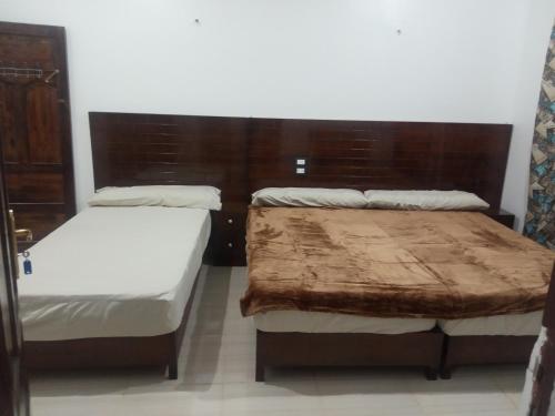 two beds in a small room withlishes at ABAZIDO Nubian Guest House in Aswan