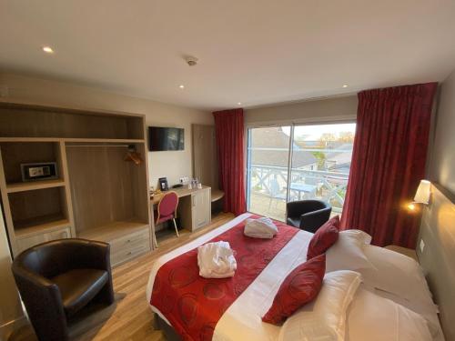 a hotel room with a bed and a balcony at Contact hôtel - Hôtel Les Bleuets & SPA in Honfleur
